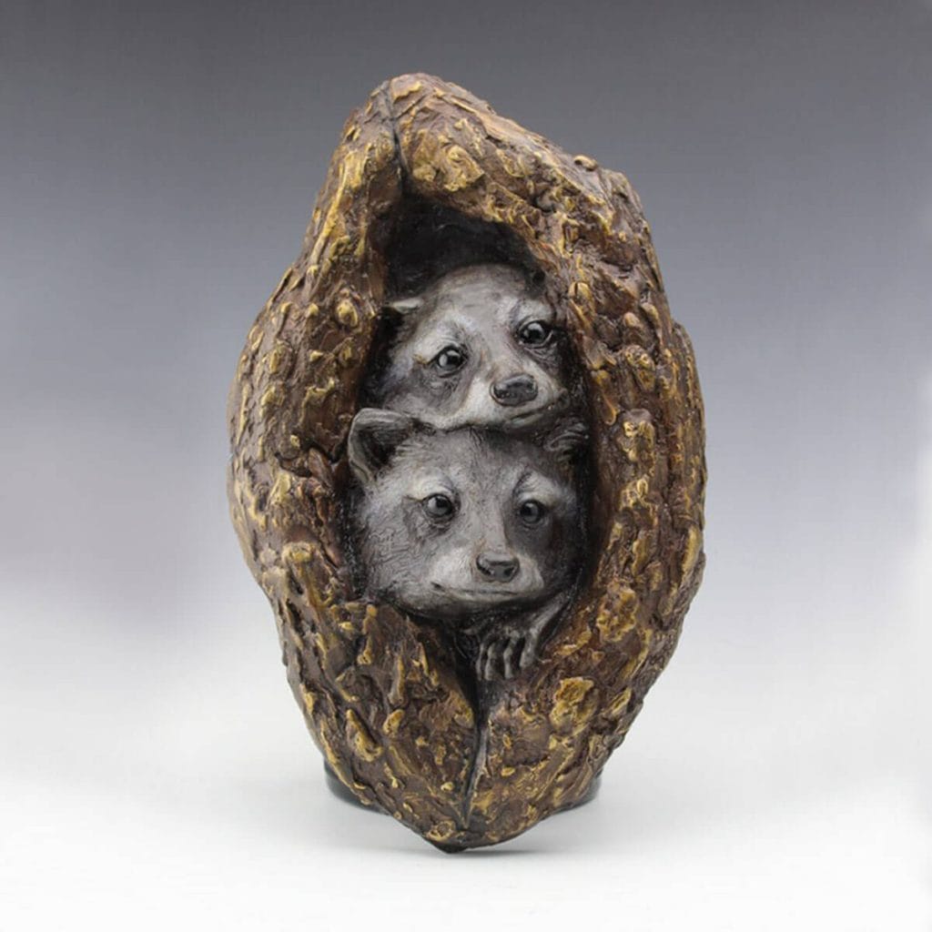 Nestled in a Knot bronze raccoon sculpture by Mark Dziewior at 7 Mile Creek Studio.