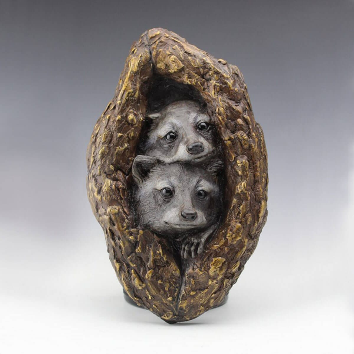 Nestled in a Knot bronze raccoon sculpture by Mark Dziewior at 7 Mile Creek Studio.